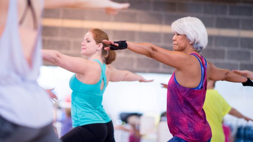Racially and age diverse group of women in a yoga class.