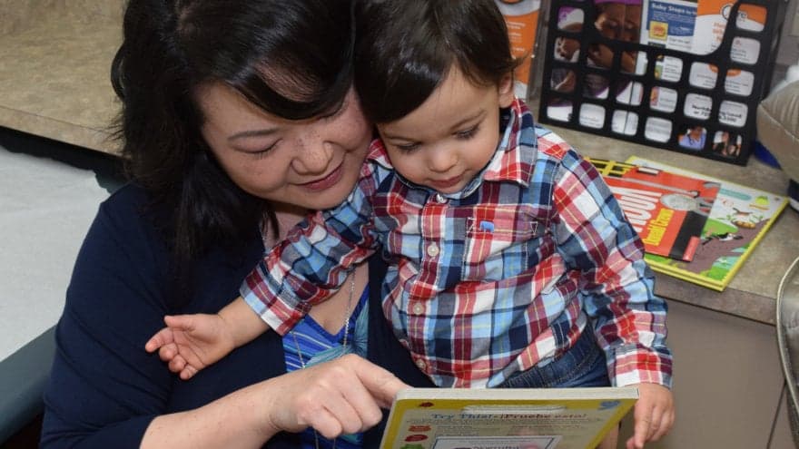 Dr. Yang reading to one of her pediatric patients.
