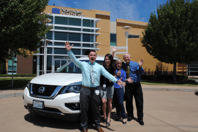 Enthusiastic new car owners Chase Goodson and Tara Sharifzadeh with their car won in the Wine and Food Jubilee and gifted from Chase's parents, PJ and Ray Goodson.