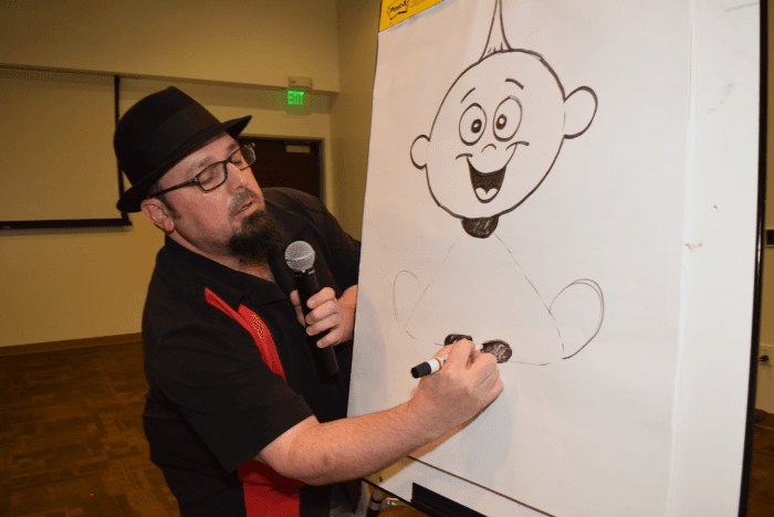 Adam Burke illustrates Jack-Jack, a character from The Incredibles, during a NorthBay management team meeting in December 2017.