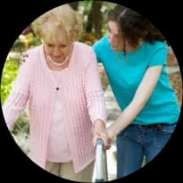 A hospital volunteer helps a patient walking