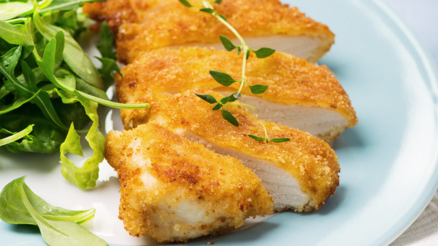 Golden brown, panko breaded air-fried chicken breast with fresh salad.