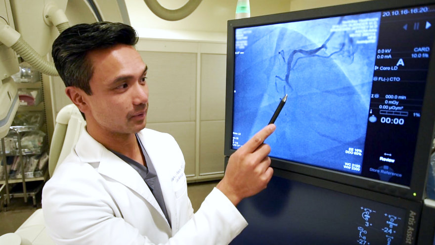 Interventional cardiologist Mark Villalon, M.D., reviewing a high resolution digital image of a patient's blood vessels.