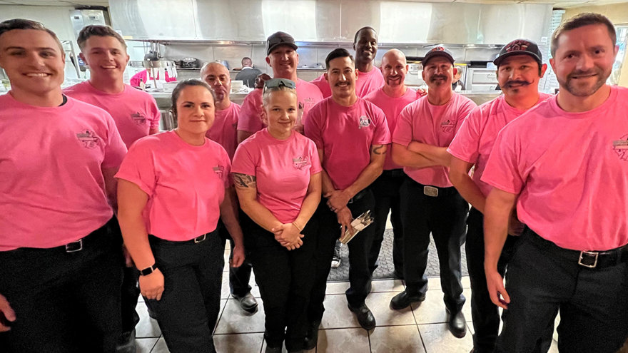 Group of firefighters dressed in pink in support of Breast Cancer.