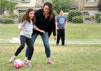 Chrystina Collins enjoying a casual round of soccer with her children.