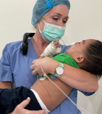 Lisa Littlefield comforts a cleft palate patient awakening from anesthesia.