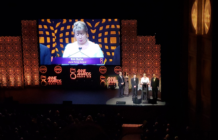 Kim Burke accepts the June Foray award on behalf of her late husband Adam Burke during the annual Annie Awards in Los Angeles.