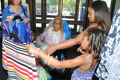 Tempie Williams' great-granddaughters vie for her vote of approval on clothing choices.