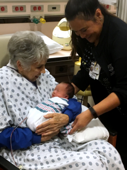 Anna Tiss, R.N., (right) checks to assure that trained cuddler Gayle Ratliff is comfortable.