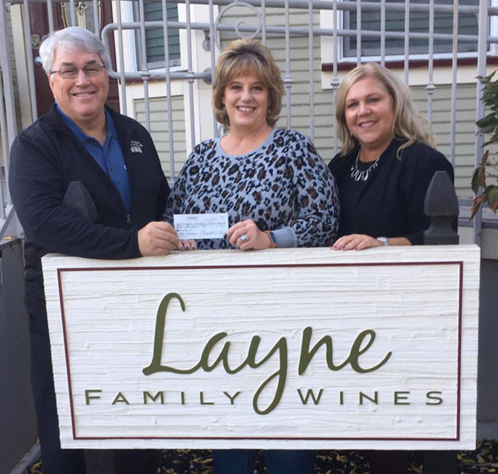 NorthBay Healthcare Foundation President Brett Johnson (left to right), Beth Anew Layne, of Layne Family Wines, and Susan Cianci, Foundation program coordinator/executive assistant, pose with a donation raised during Layne’s October Rose’ special event.