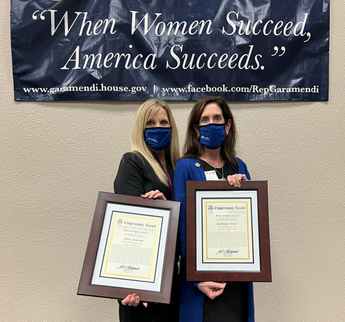 Mary Jameson (above, left) and Stephanie Tarter hold the plaques they received from Rep. John Garamendi during a special reception honoring 42 Women of the Year in Woodland last week.