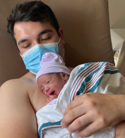 New dad Rodrigo Rodriguez cuddles with baby Rafael (a twin).