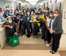 Nick Dela Pena and Tayler Tildsley (front row, holding bouquets), both clinical nurses on Unit 1600-1700, were honored with the DAISY award during a recent presentation, and many on the team turned out to cheer them on.