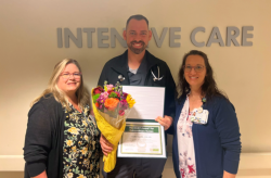 Collin Norville, R.N., shows off his DAISY Award with Kim Williamson, Senior Manager of Critical Care and CardioPulmonary Services, (left) and Jennifer Veler, R.N., Clinical Manager Critical Care Services.