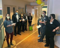 Critical Care Services Clinical Manager Jennifer Veler (left) reads a letter honoring her team.