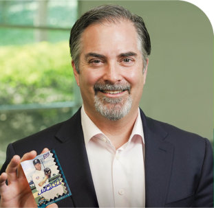 Dr. Caravelli holding up his personal baseball card.