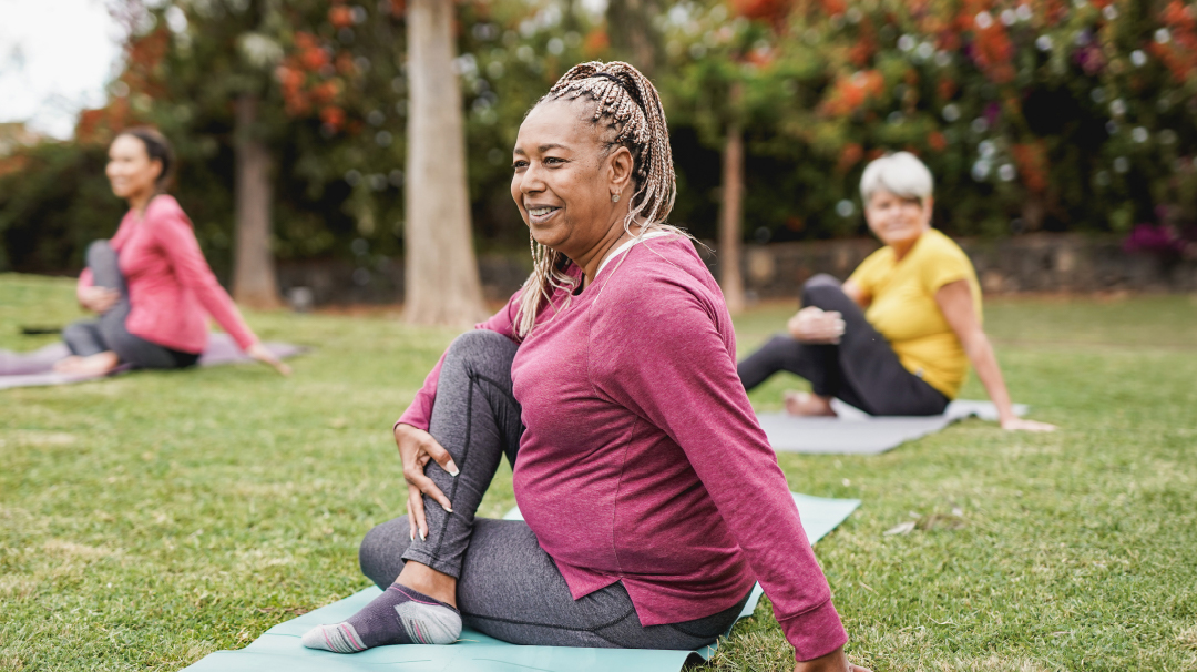 Woman participating in a yoga class in a park.